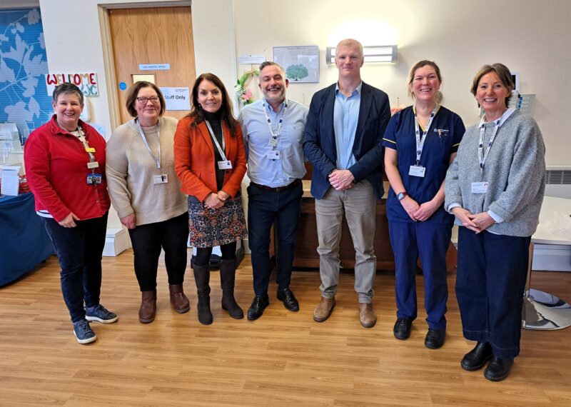 Al standing side by side with members of staff at Birmingham Hospice